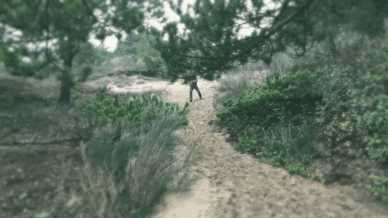 slow motion Jeremy running down a sand dune
