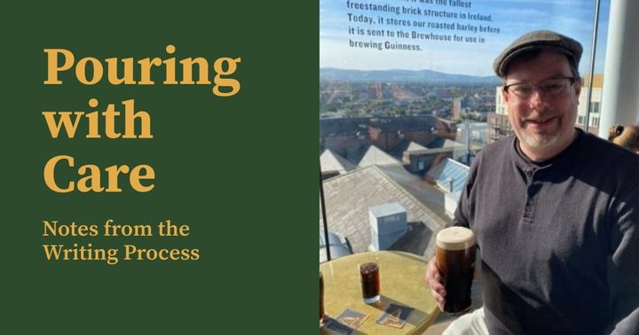 Title: Pouring with Care: Note from the Writing Process. A photo of the author holding a perfect pint in the Gravity Bar at the Guinness Storehouse, the Dublin cityscape in the background.
