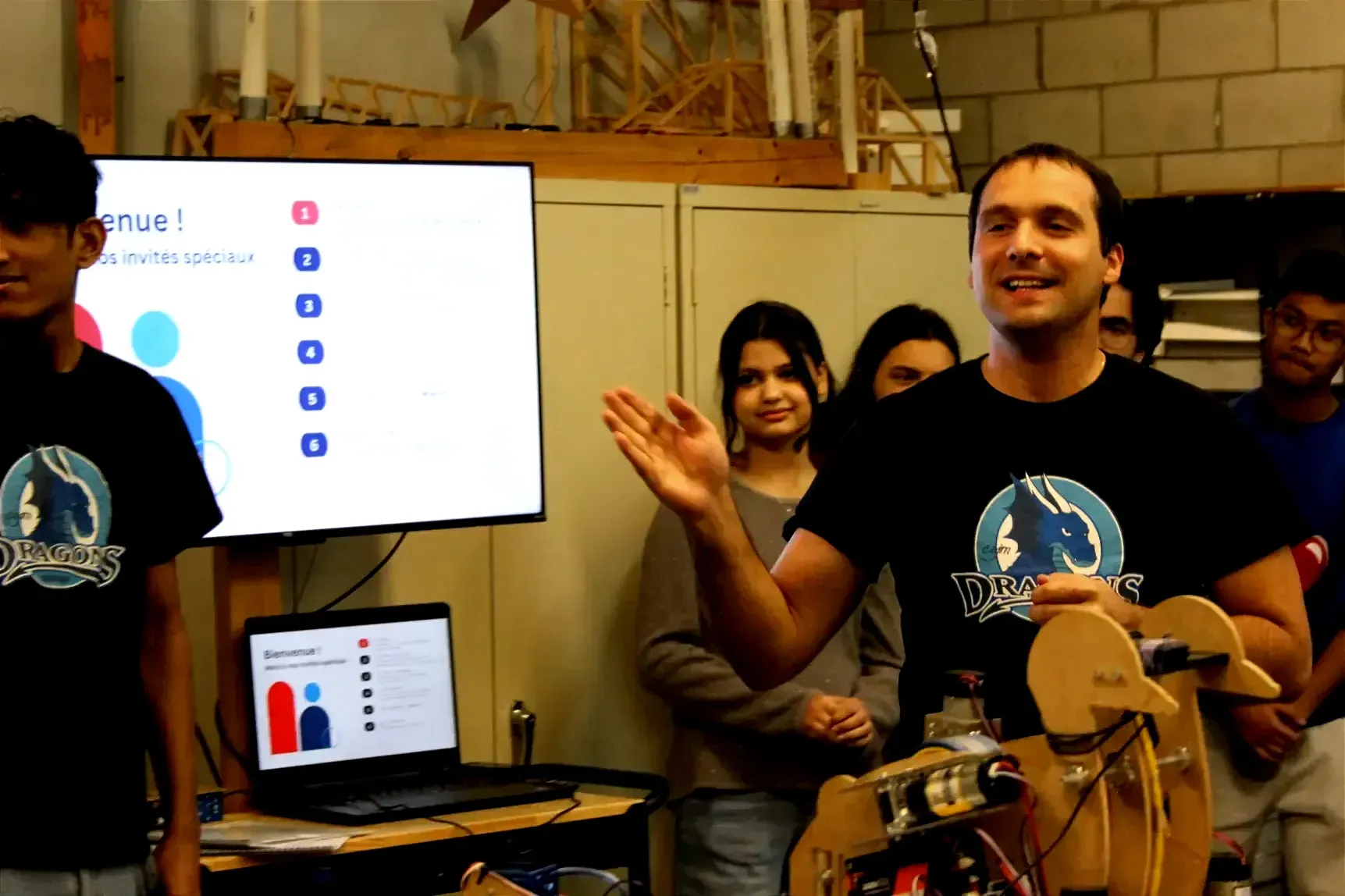 M. Le Chevoir gesticule derrière le robot en forme de cycne et devant quelques élèves.
