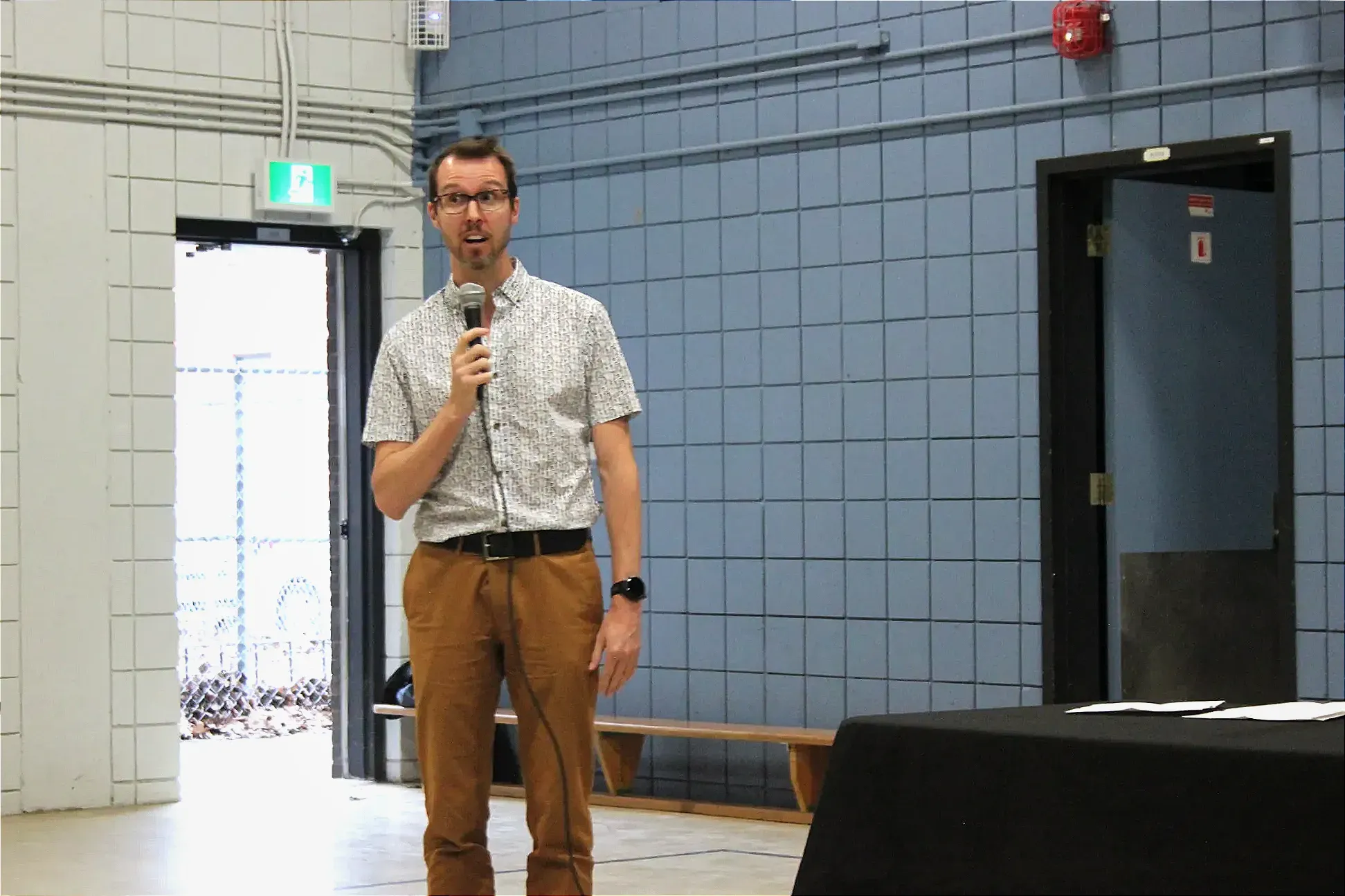 M. Fortin prend la parole dans le gymnase de l'école. 