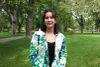 Kelly-Anne Gagné, portant un veston coloré de bleu et de turquoise, pose dans le parc Sir-Wilfrid Laurier.