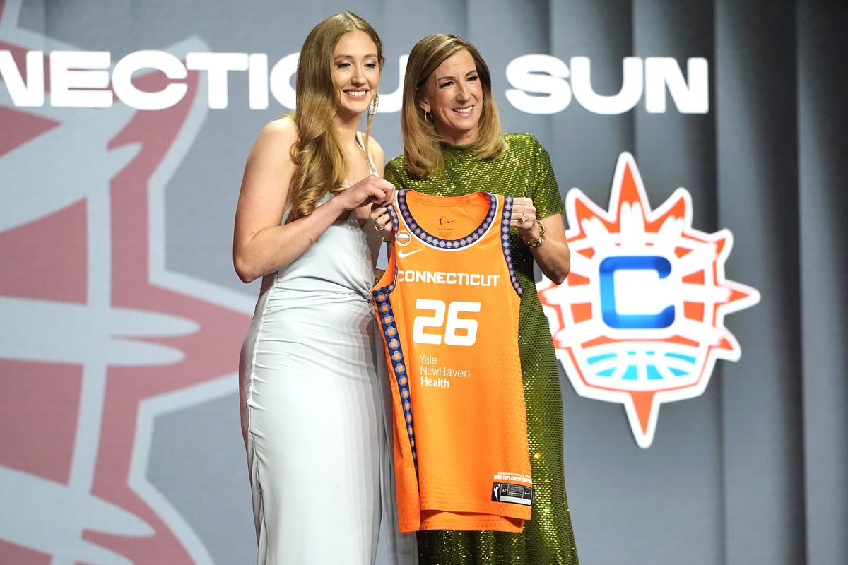 Connecticut Sun No. 26 overall draft pick Gianna Kneepkens holding a Sun jersey with WNBA commissioner Cathy Engelbert at the 2026 WNBA Draft