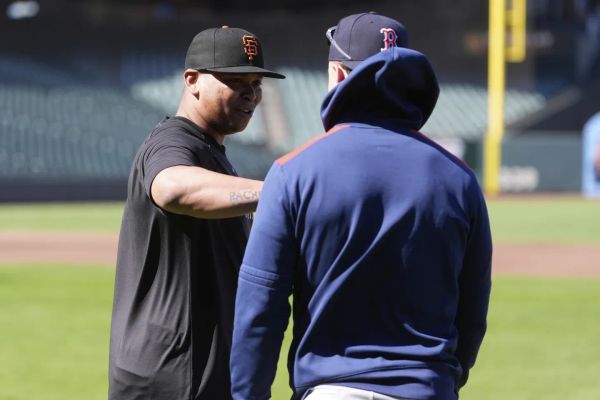 San Francisco Giants' Rafael Devers talks with Red Sox's Romy Gonzalez before a June 20, 2025 game