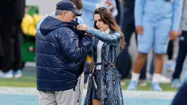 Jordon Hudson adjusts Bill Belichick's coat during North Carolina's practice