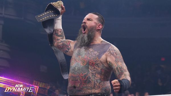 Brody King holding the AEW world title after squashing MJF