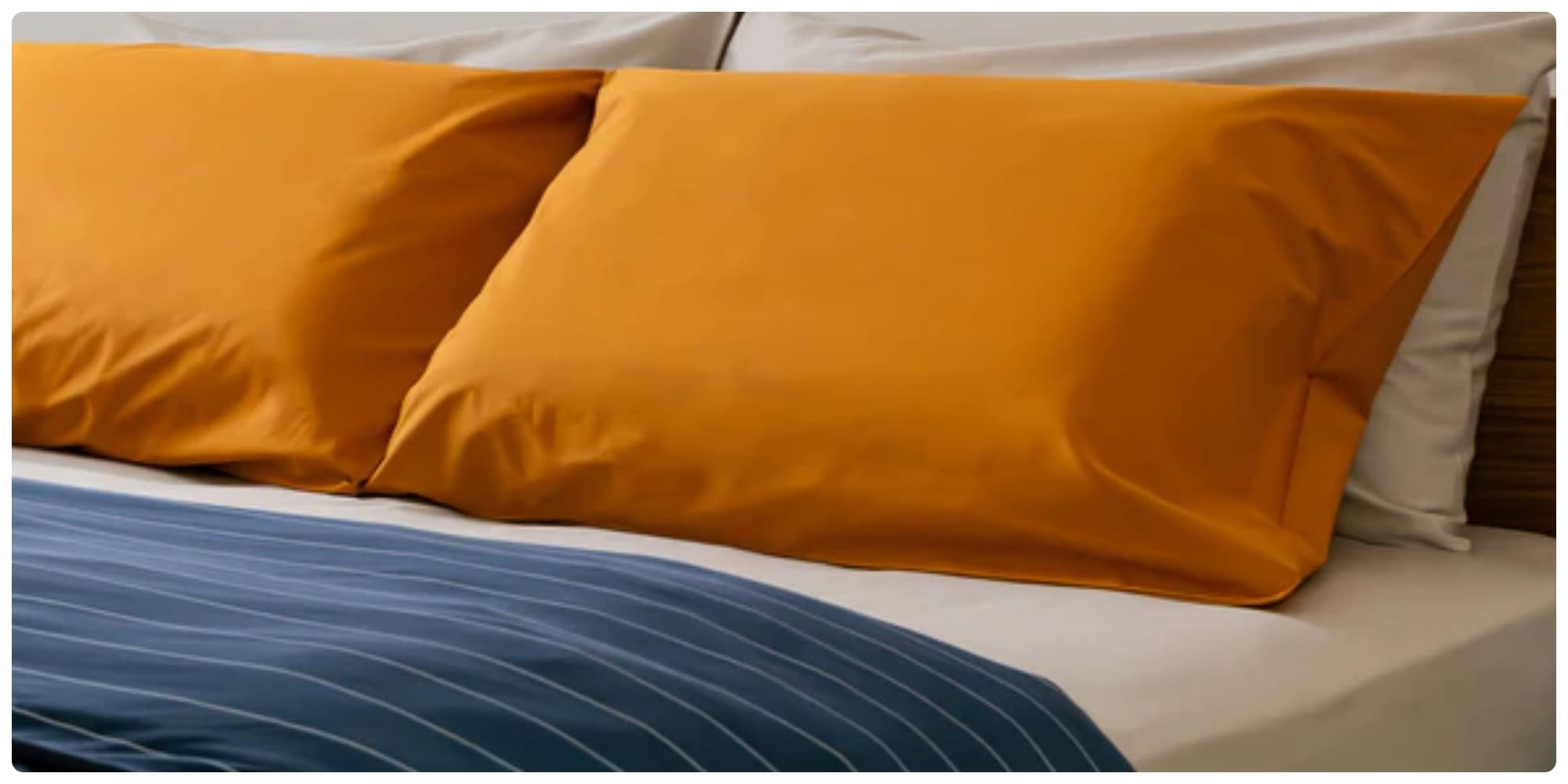 Organic cotton bedding by SOJAO, neatly arranged on a minimalist bed setup.