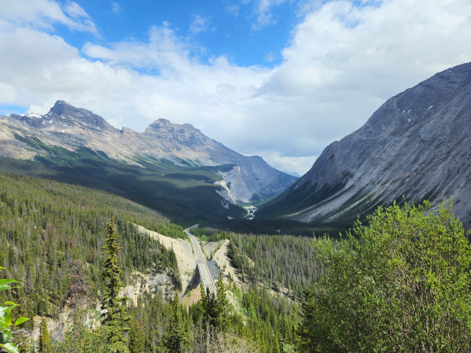 Road winds through Canadian Rockies between Banff and Jasper on the Icefields Parkway, the scenic drive into Jasper National Park