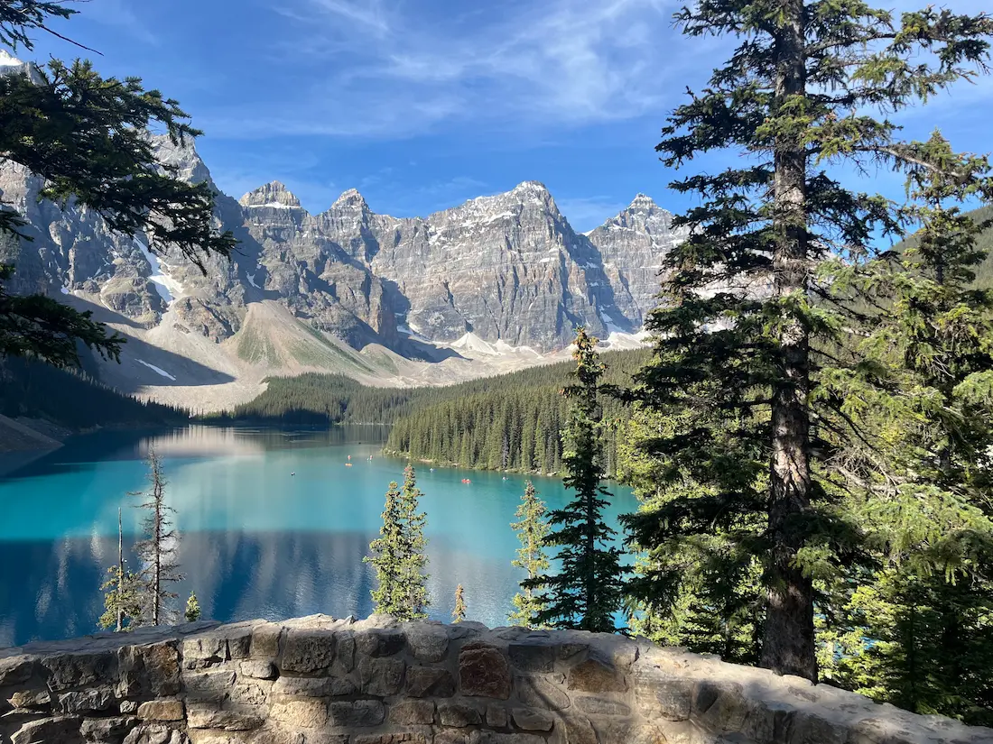 Moraine Lake stone wall viewpoint red canoes turquoise water Valley of Ten Peaks Banff National Park