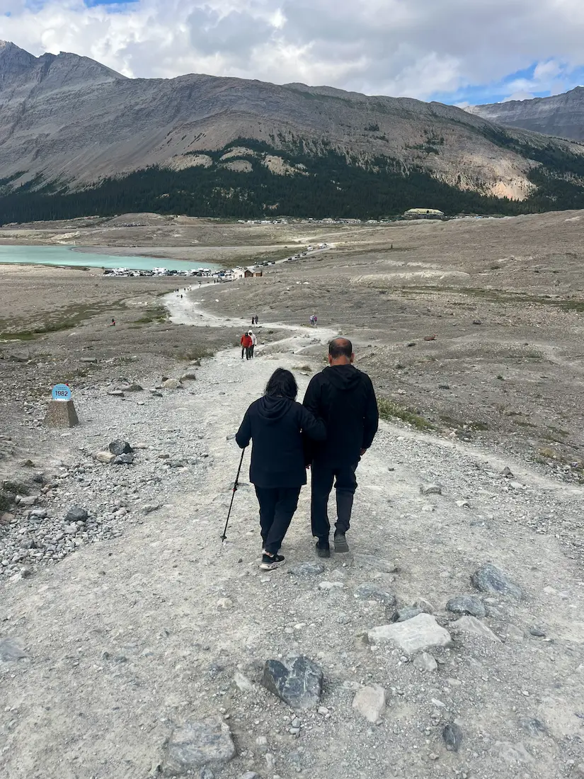 Athabasca Glacier Icefields Parkway family standing on glacier ice Jasper National Park