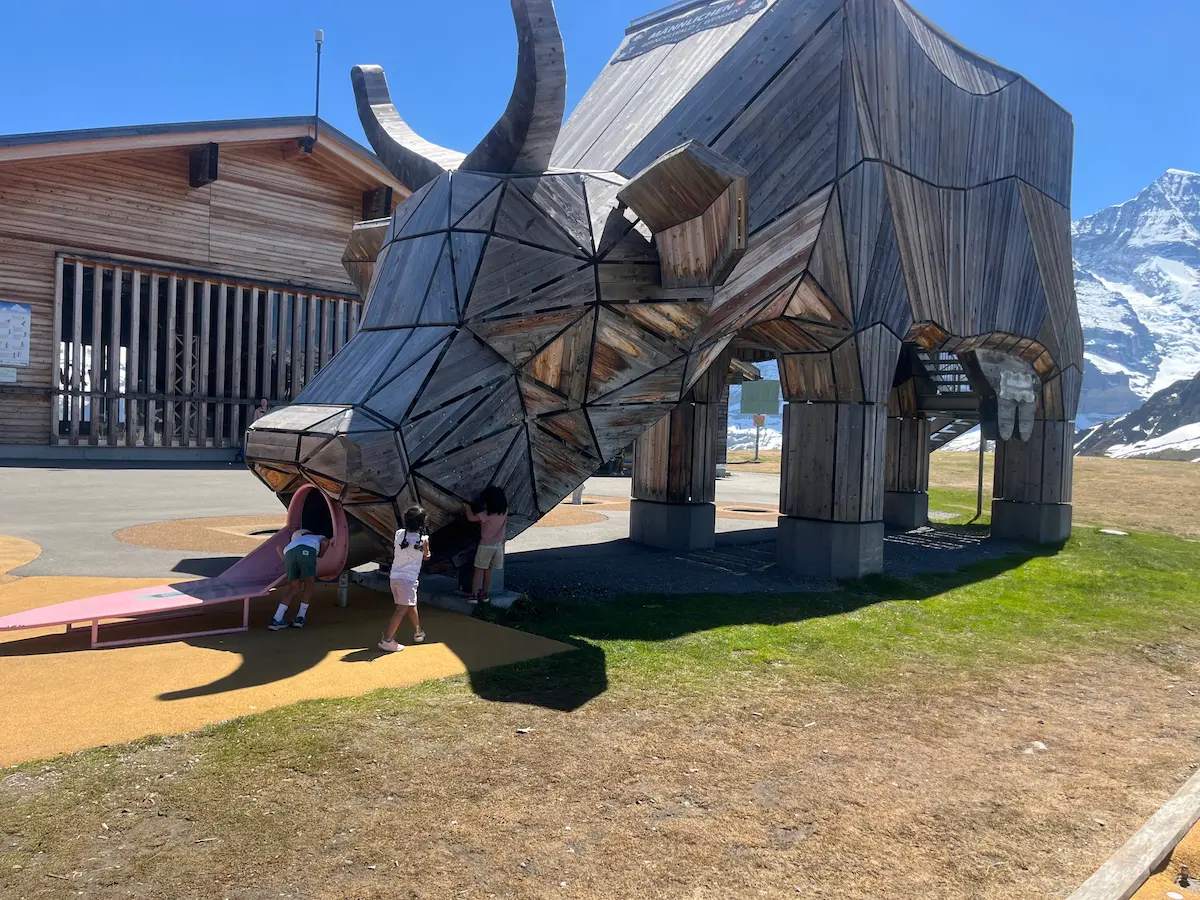 Giant wooden cow slide at Männlichen playground, Jungfrau Region, Switzerland