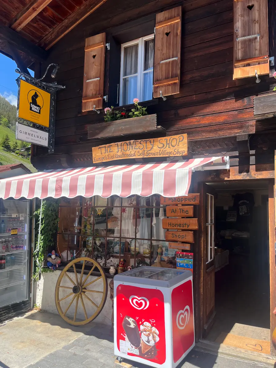 Village street with shops and red awning, Wengen Jungfrau region Switzerland