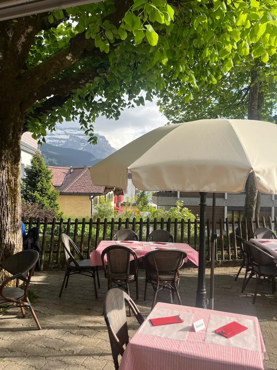 Outdoor restaurant terrace with mountain views Wengen Switzerland, family dining car-free village Jungfrau region