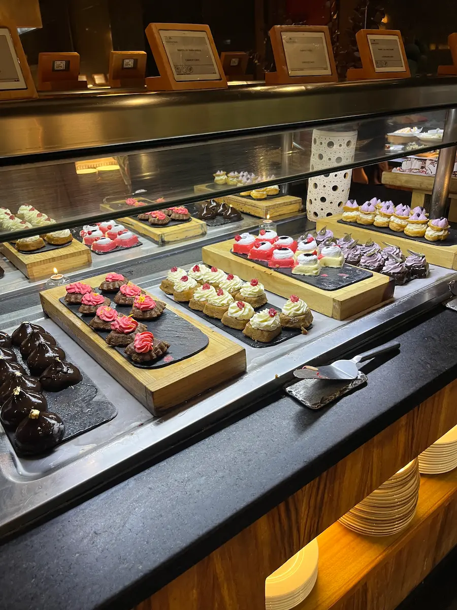 Dessert display case with assorted pastries and sweets at the Naos buffet, Paradisus Playa del Carmen.