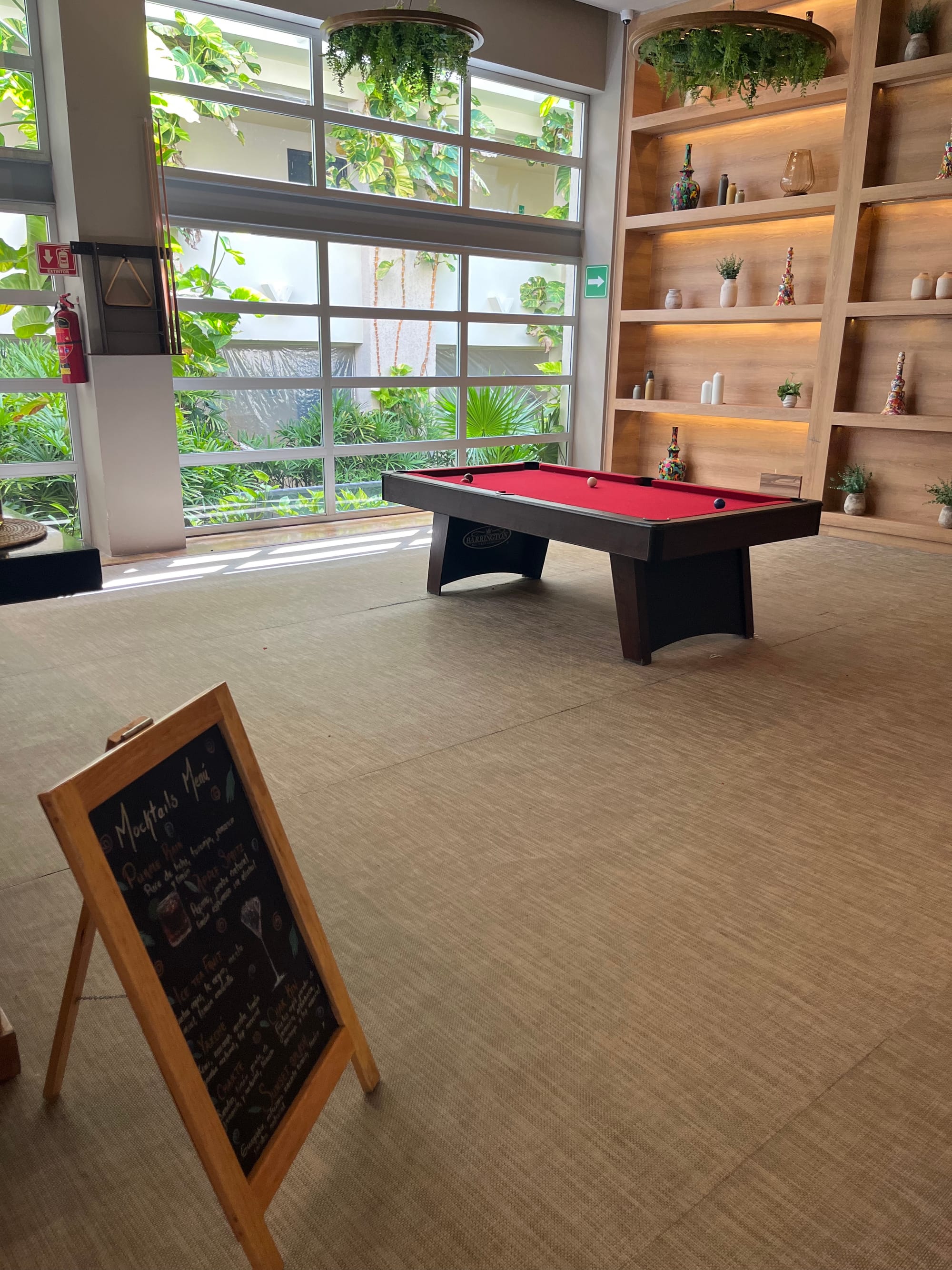 A red pool table in the teenage area of the hotel