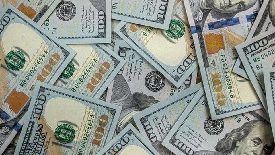 100 new US dollar bills on black background