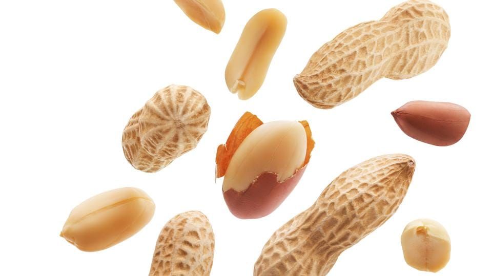 Peeled, unpeeled and whole shell peanuts isolated on white background