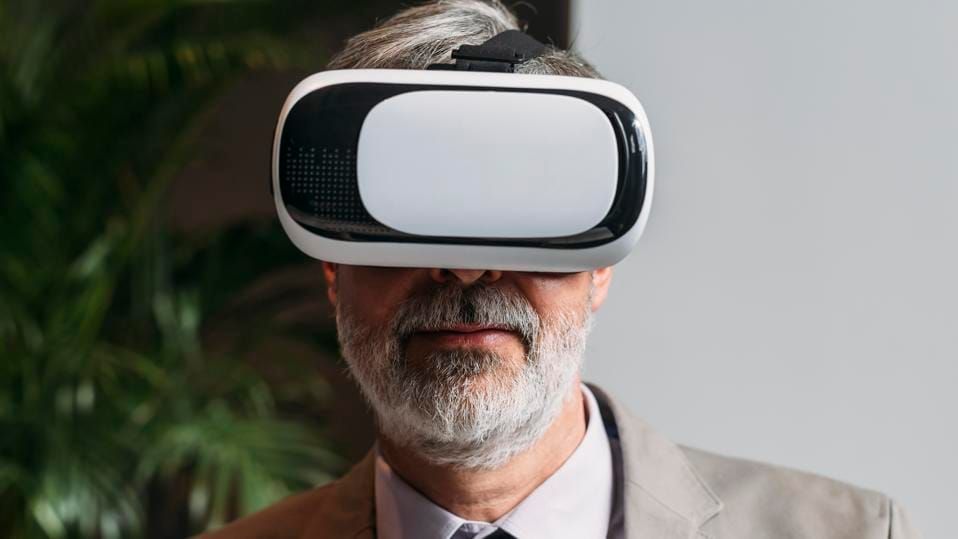 Man in suit wearing an Oculus VR headset