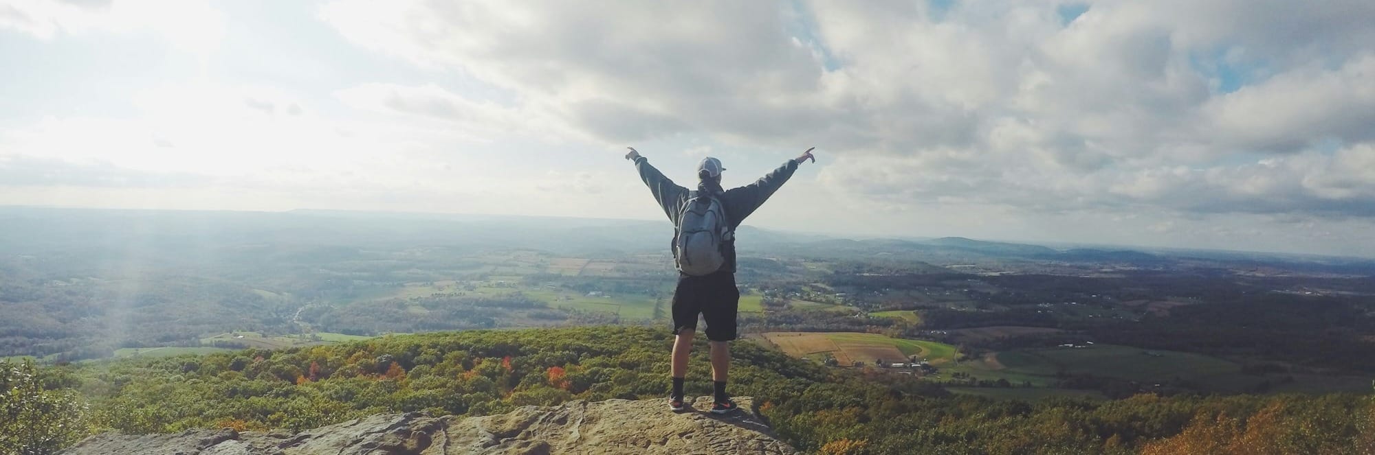 man standing on top of the mountain