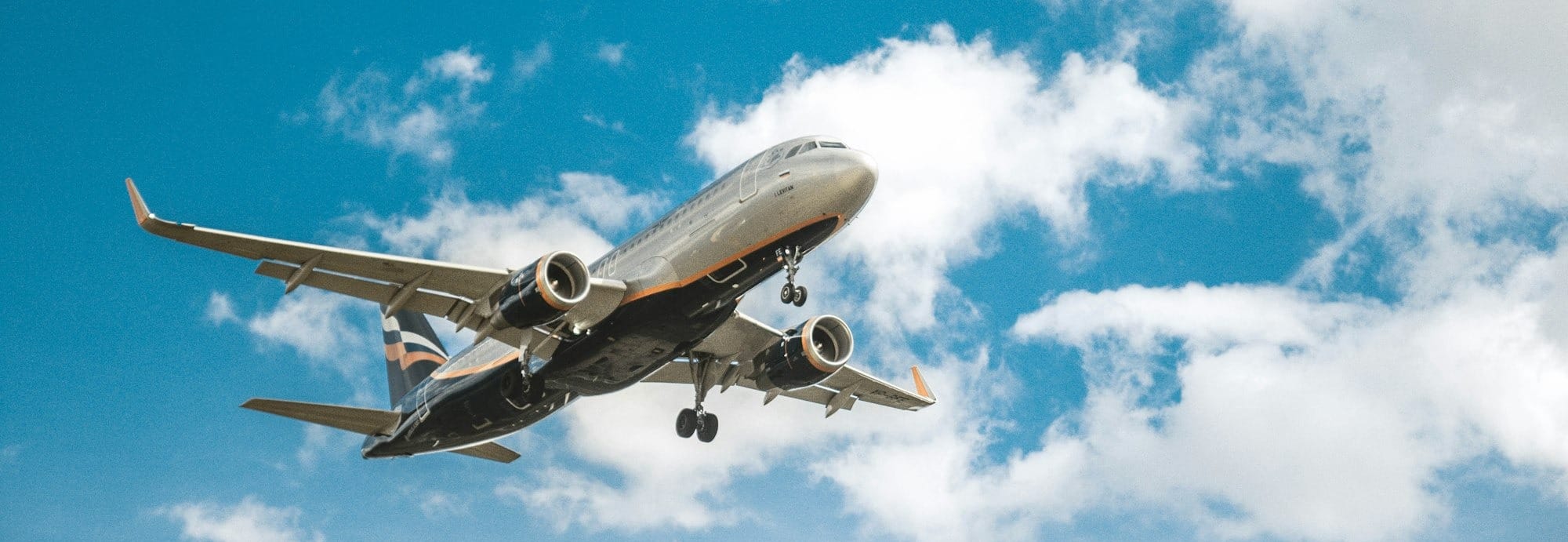 white airplane under blue sky during daytime