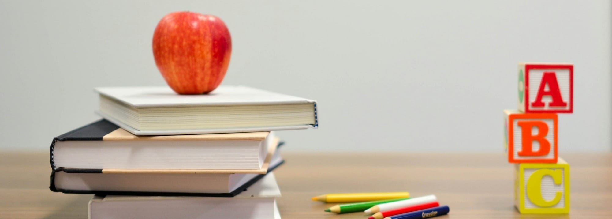 red apple fruit on four pyle books