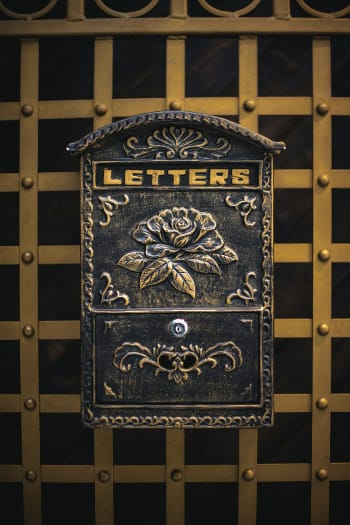An ornate mailbox displays the word "letters".