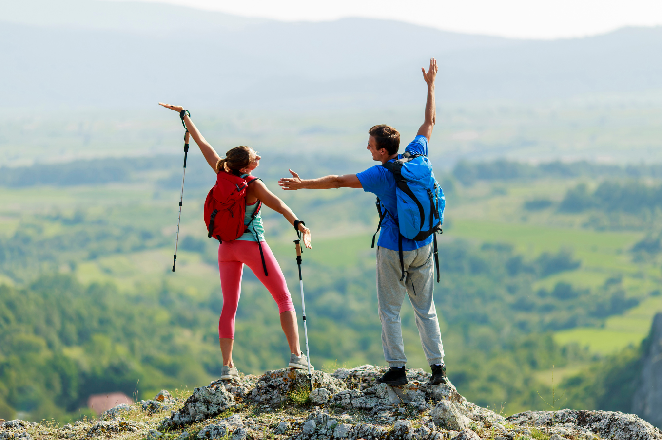 A couple celebrating reaching the summit on a hike together