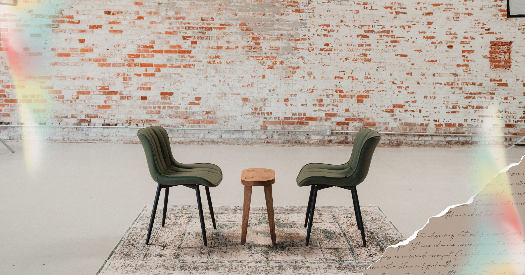 Picture of two green chairs facing each other in front of a red brick wall