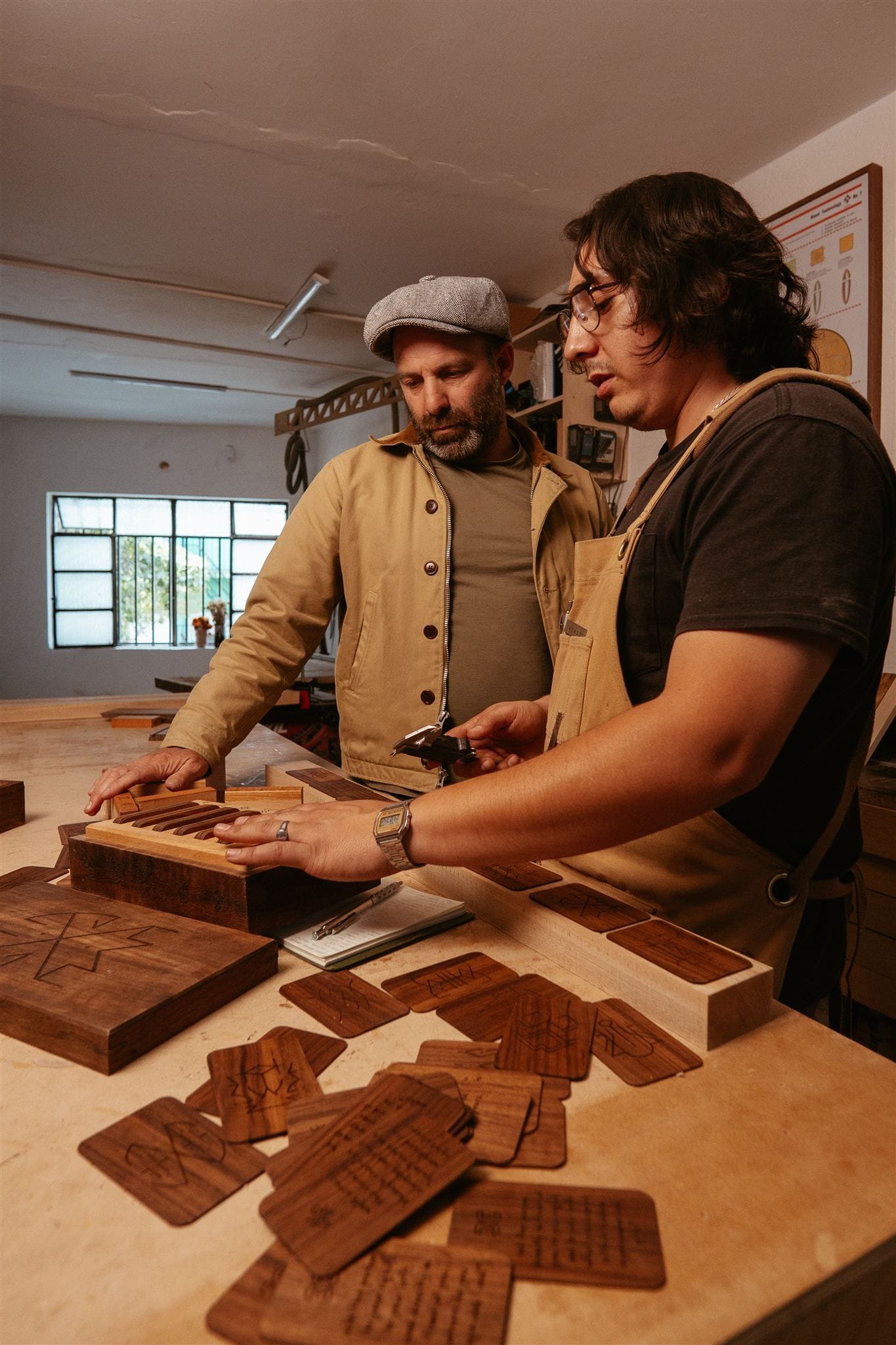 Two men looking at a wooden box and cards
