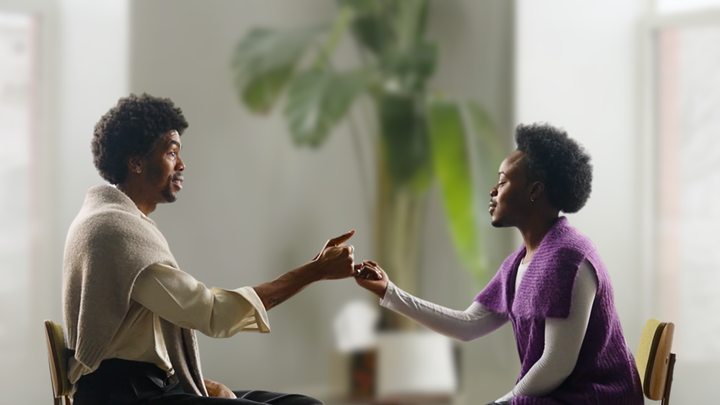 Two men having a conversation and making a pinky promise while experiencing {THE AND}