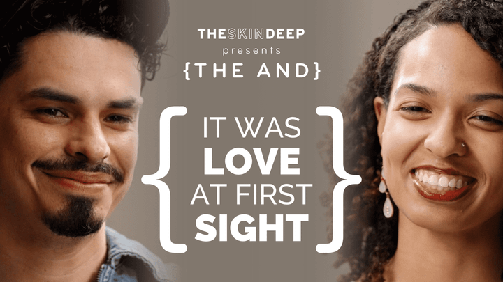 A couple sitting face to face smiling