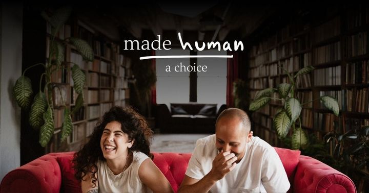 A couple laughing together on a couch