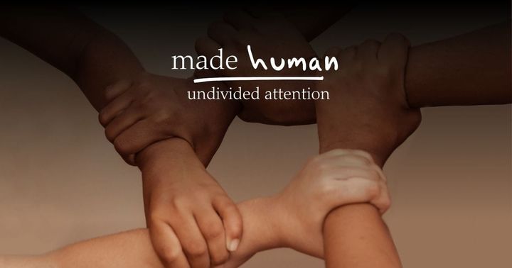 four people holding each other's wrists in a square 