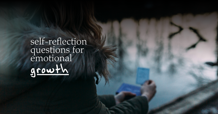 Picture of a girl wearing a jacket and standing by a river holding a card with a reflection question