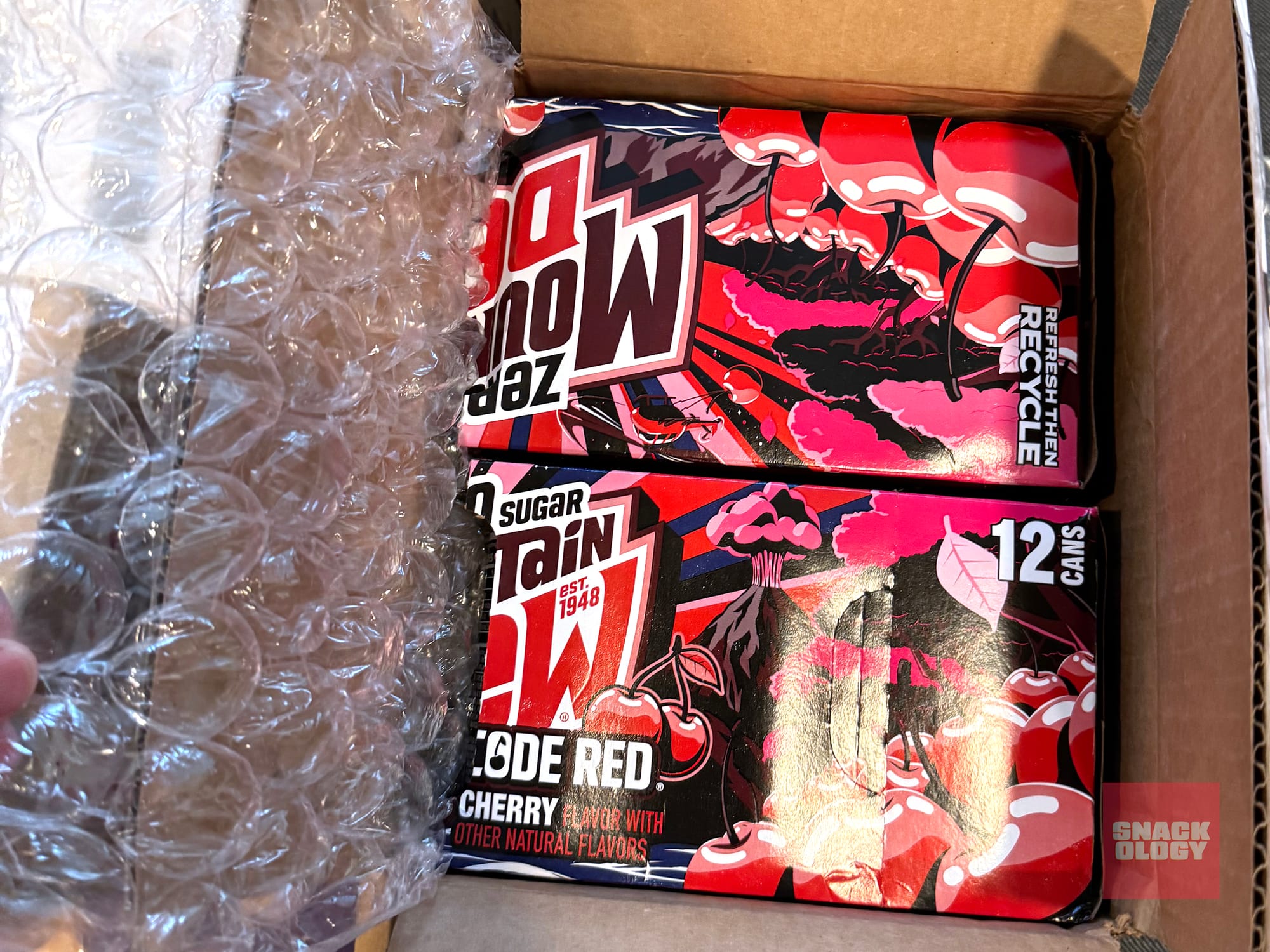 A case of Mountain Dew Code Red Zero Sugar broken in two in a box