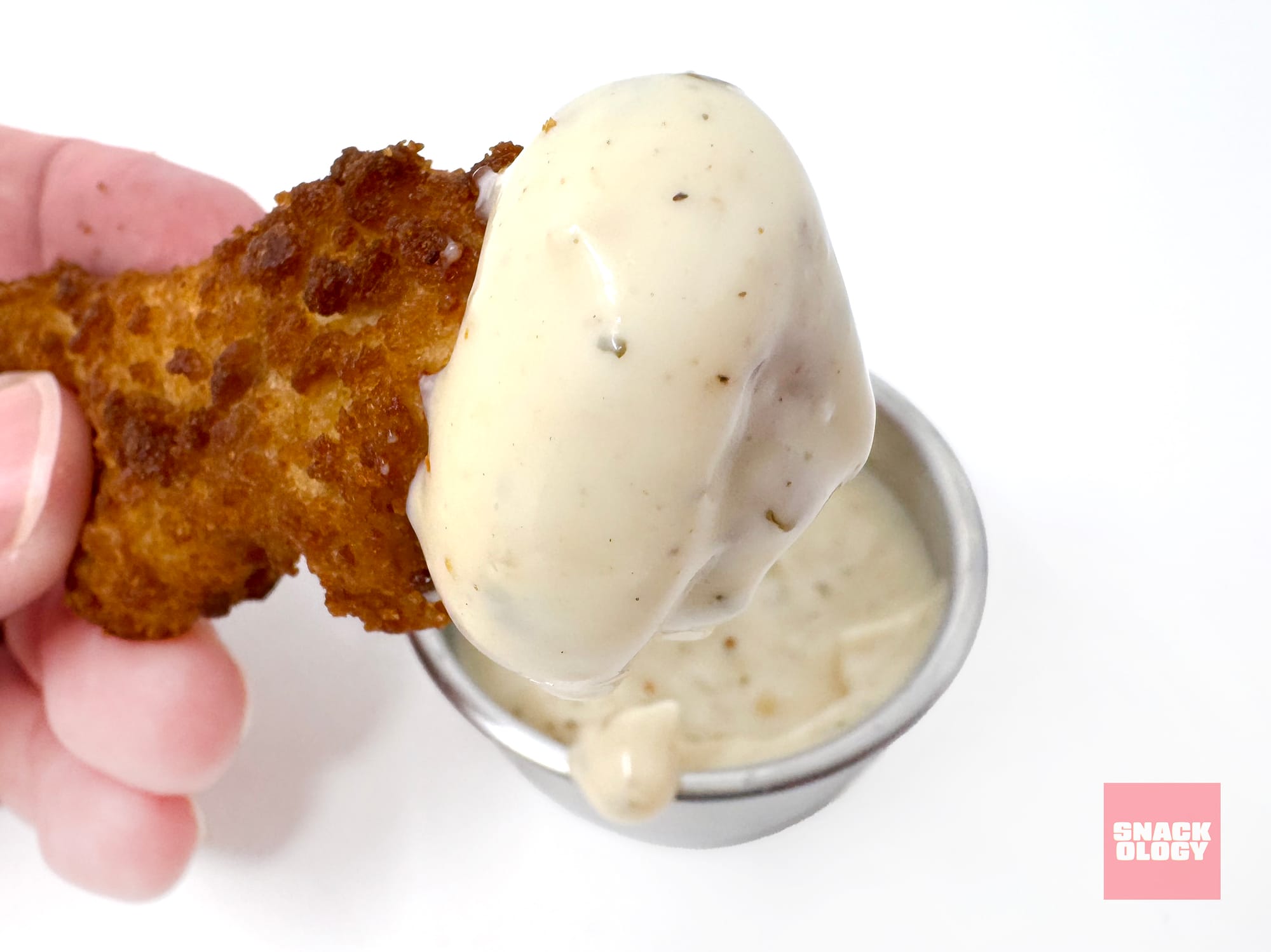 A dino nugget dipped in Heinz Buttermilk Ranch Mayonnaise-Style Dip
