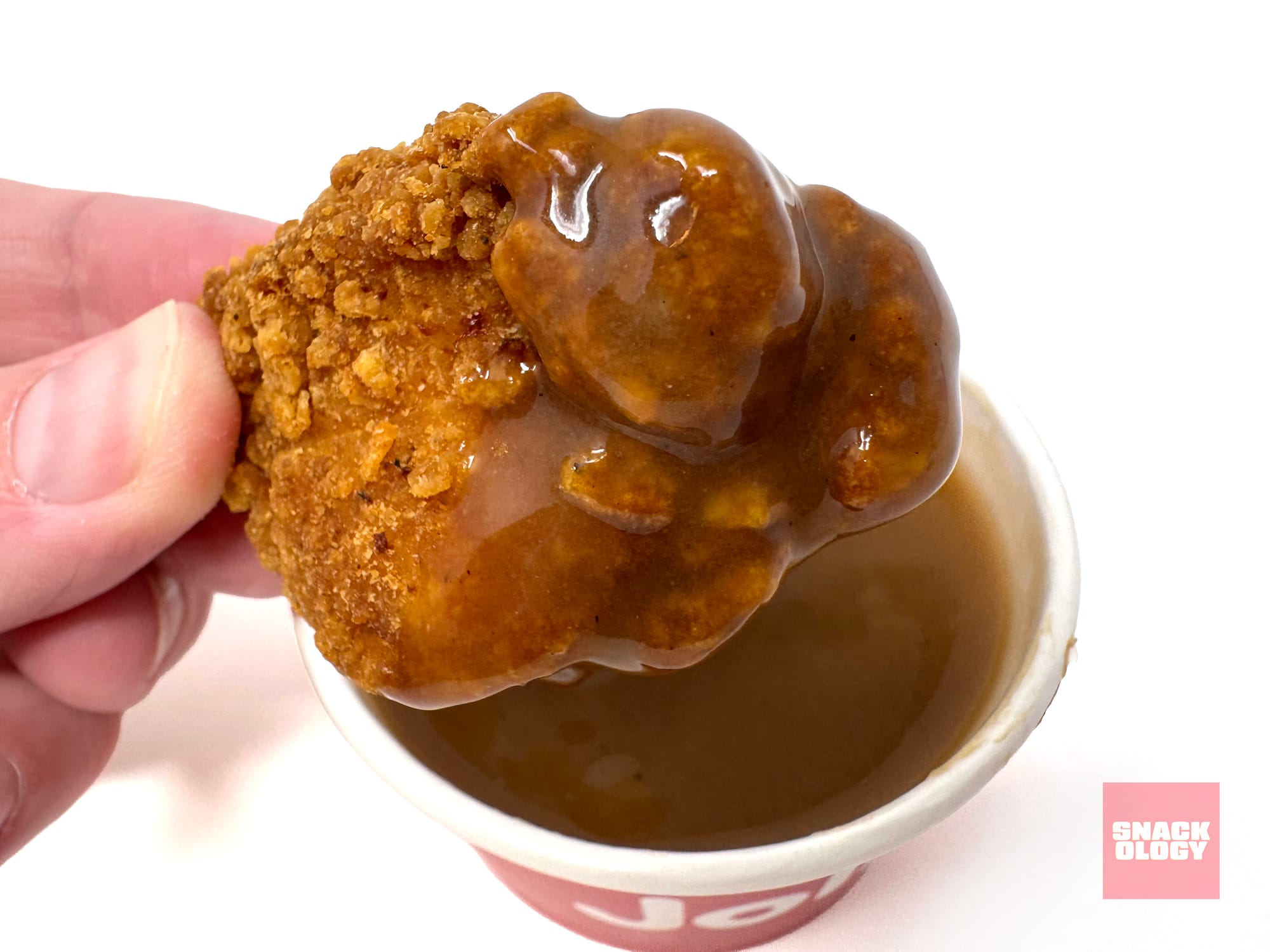 A Jollibee Chicken Nugget dipped in the chain’s “iconic” gravy