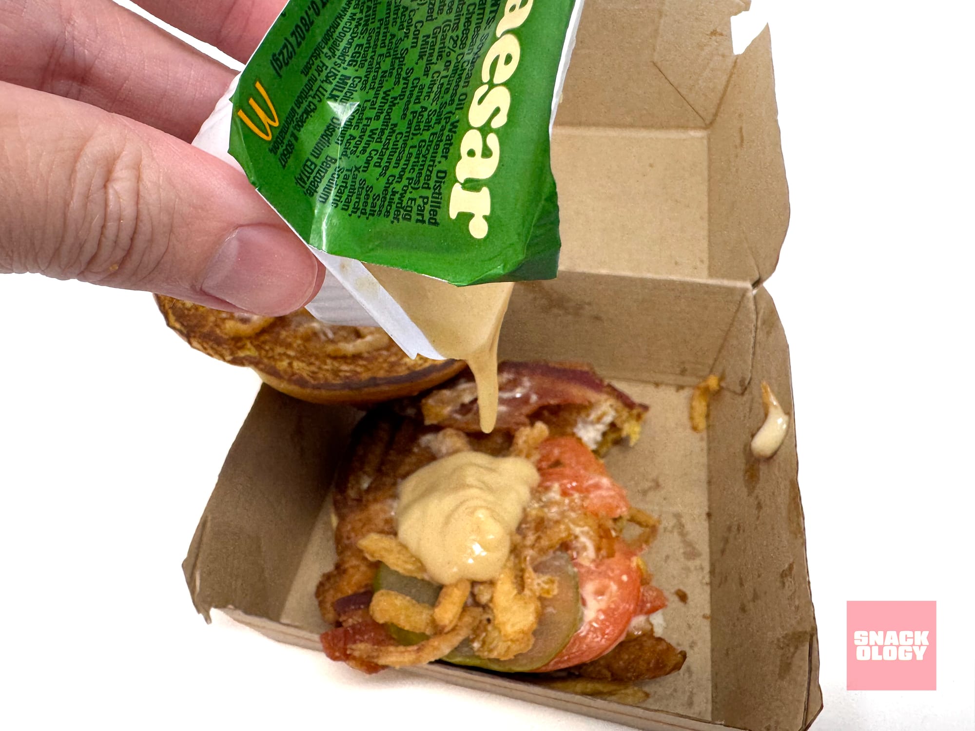 Extra Caesar Sauce going on the the Bacon Caesar McCrispy Sandwich