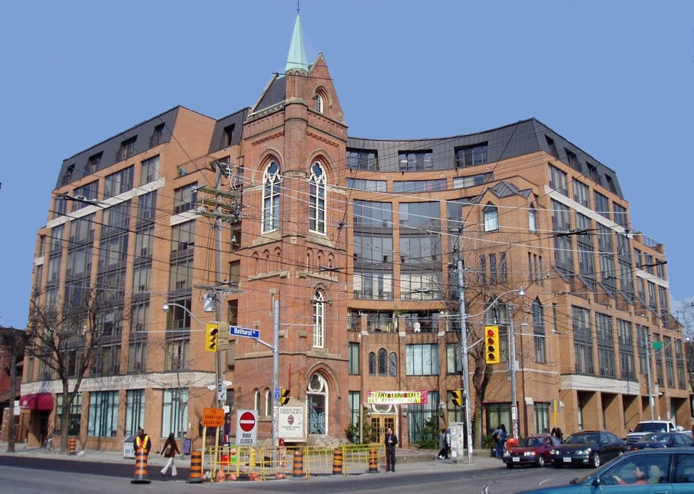 color photo of the Channel Club Condos with the remnant tower of the church