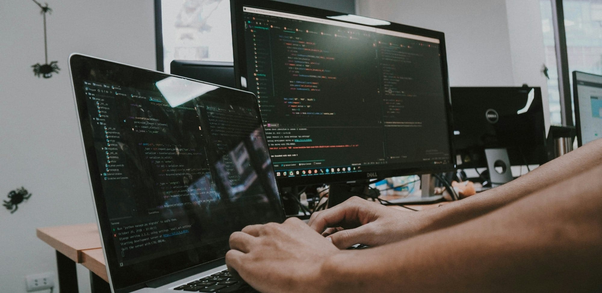 a person typing on a laptop computer on a desk