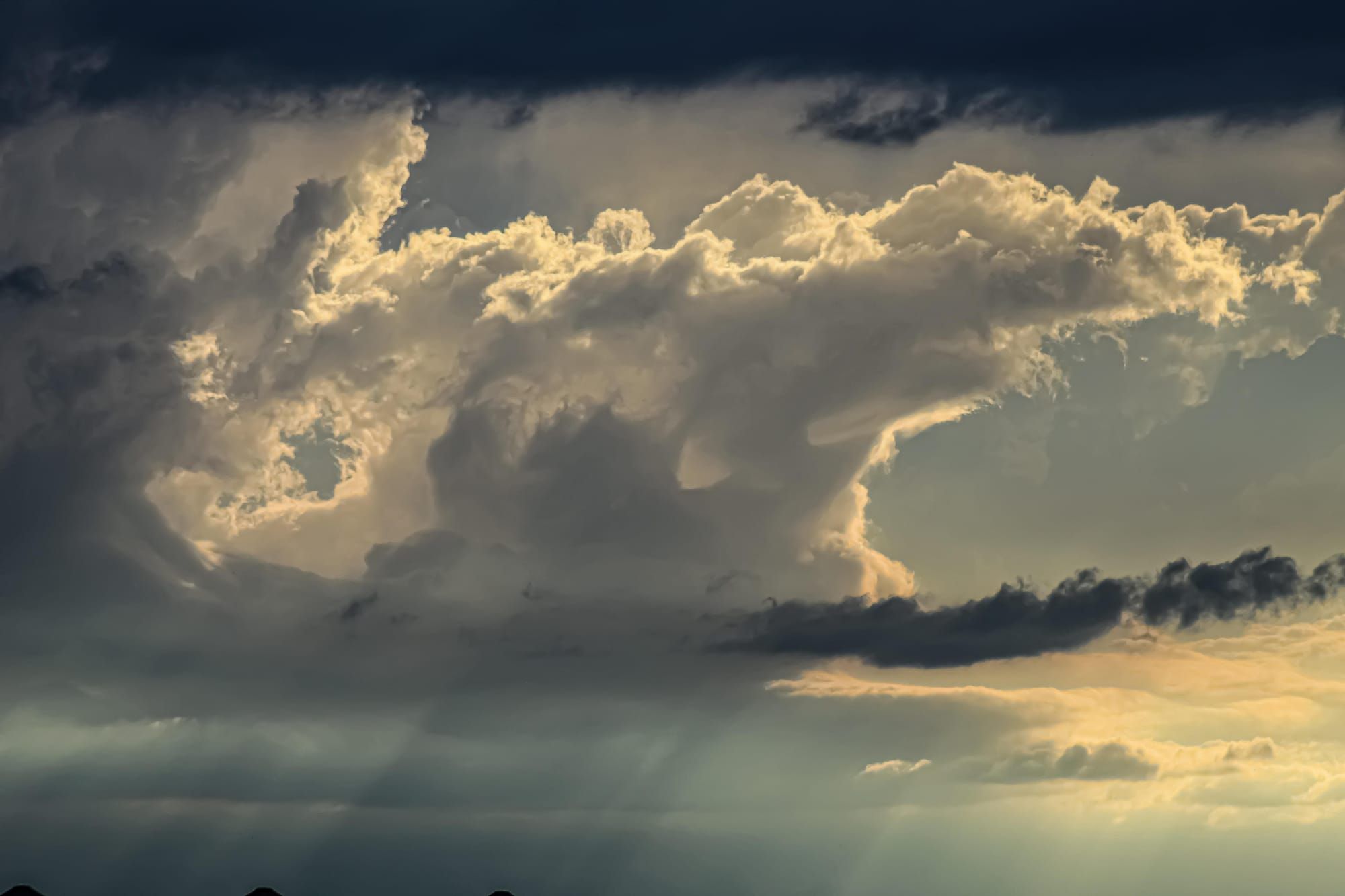 Rainstorm with clouds and sunlight in the background