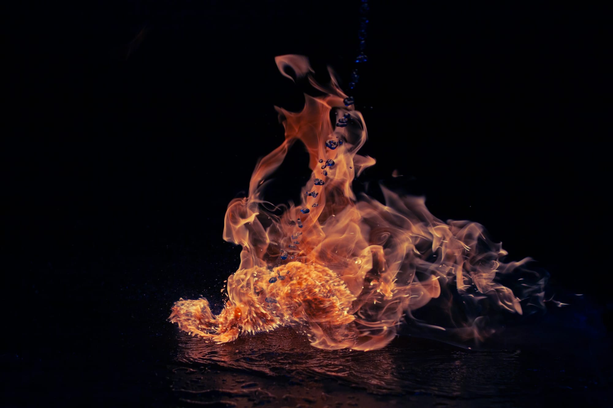 A hooded wraith rides atop a fire spirit dragon. f/2.8. 1/8000 sec. ISO 250 . 50mm. Colour temp pushed into blue.