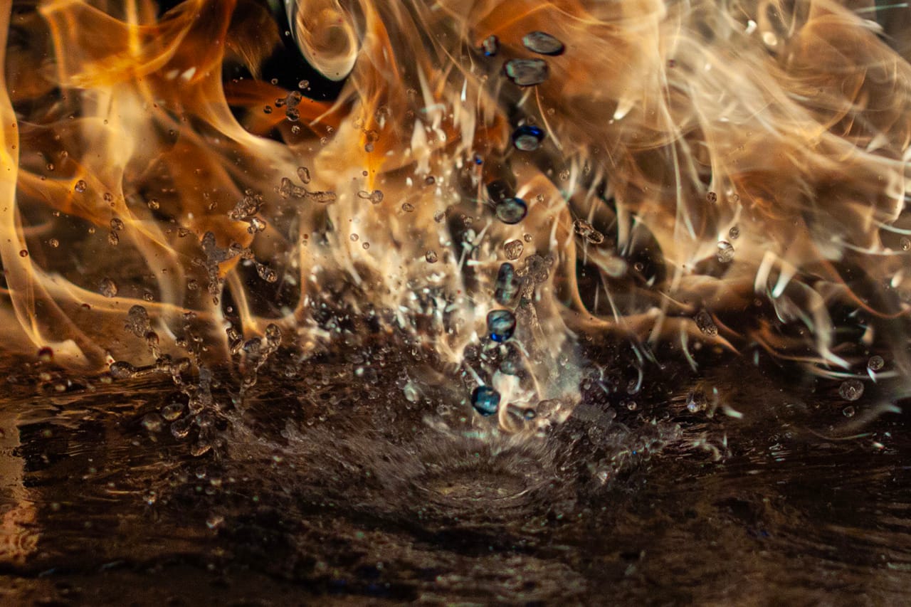 Close up. Droplets of Methylated Spirits slash onto water before catching on fire. f/2.8. 1/8000 sec. ISO 250 . 50mm.