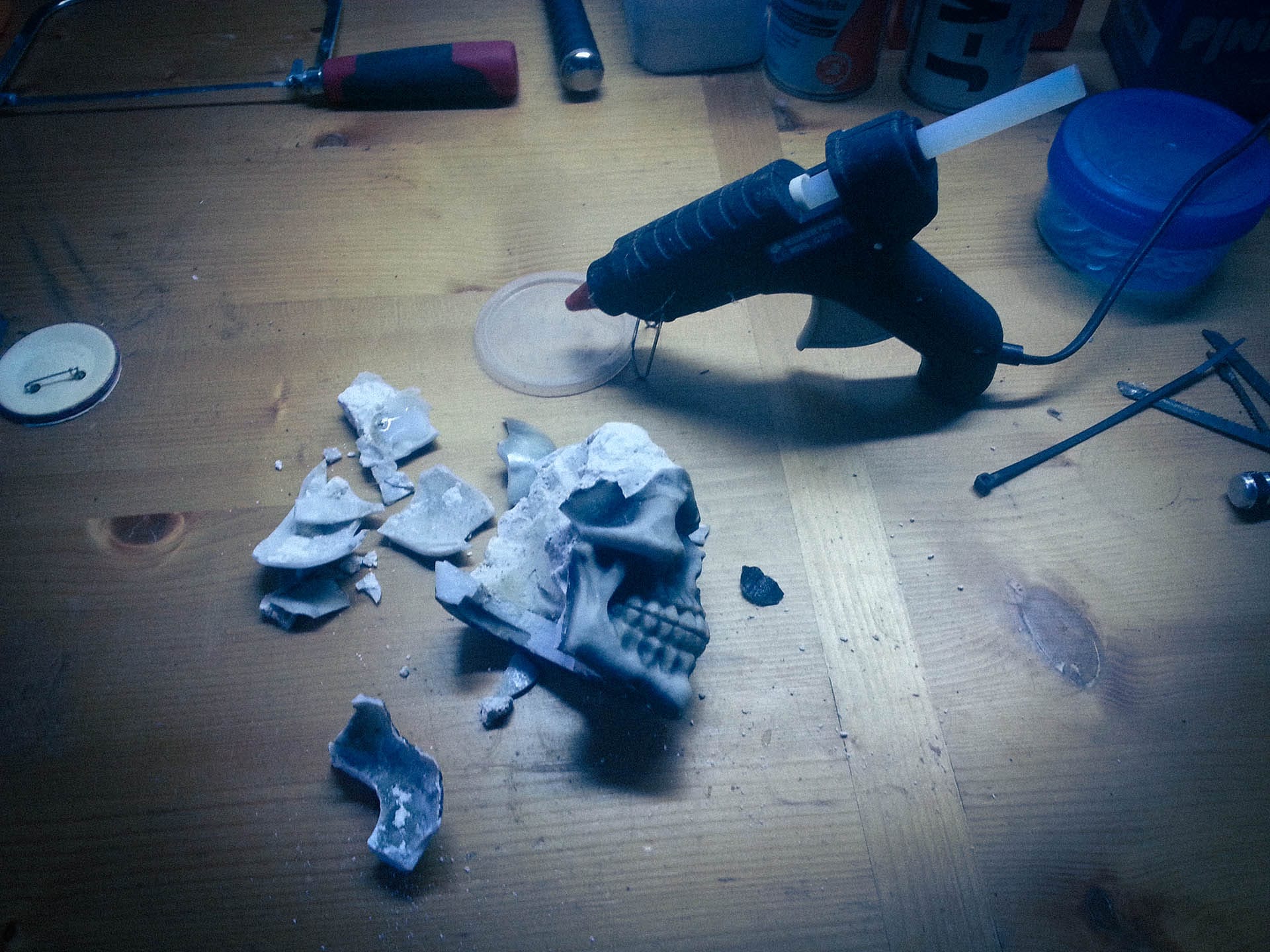 The damage is quite severe, many pieces lay all over the bench in an attempt to piece it back together with hot glue