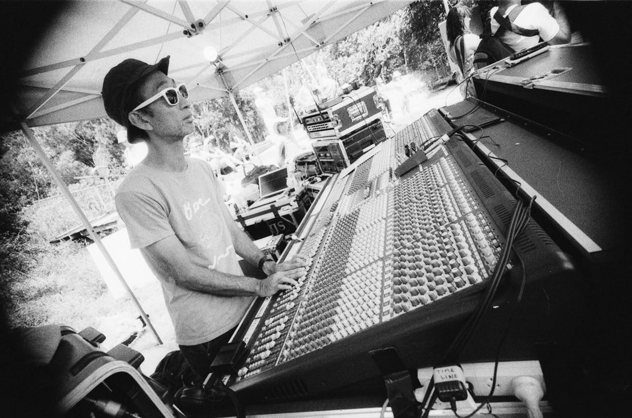 An audio engineer operates a mixing console at the Island Quarry - Boredoms - Boadrum111 - Byron Bay November 2011
