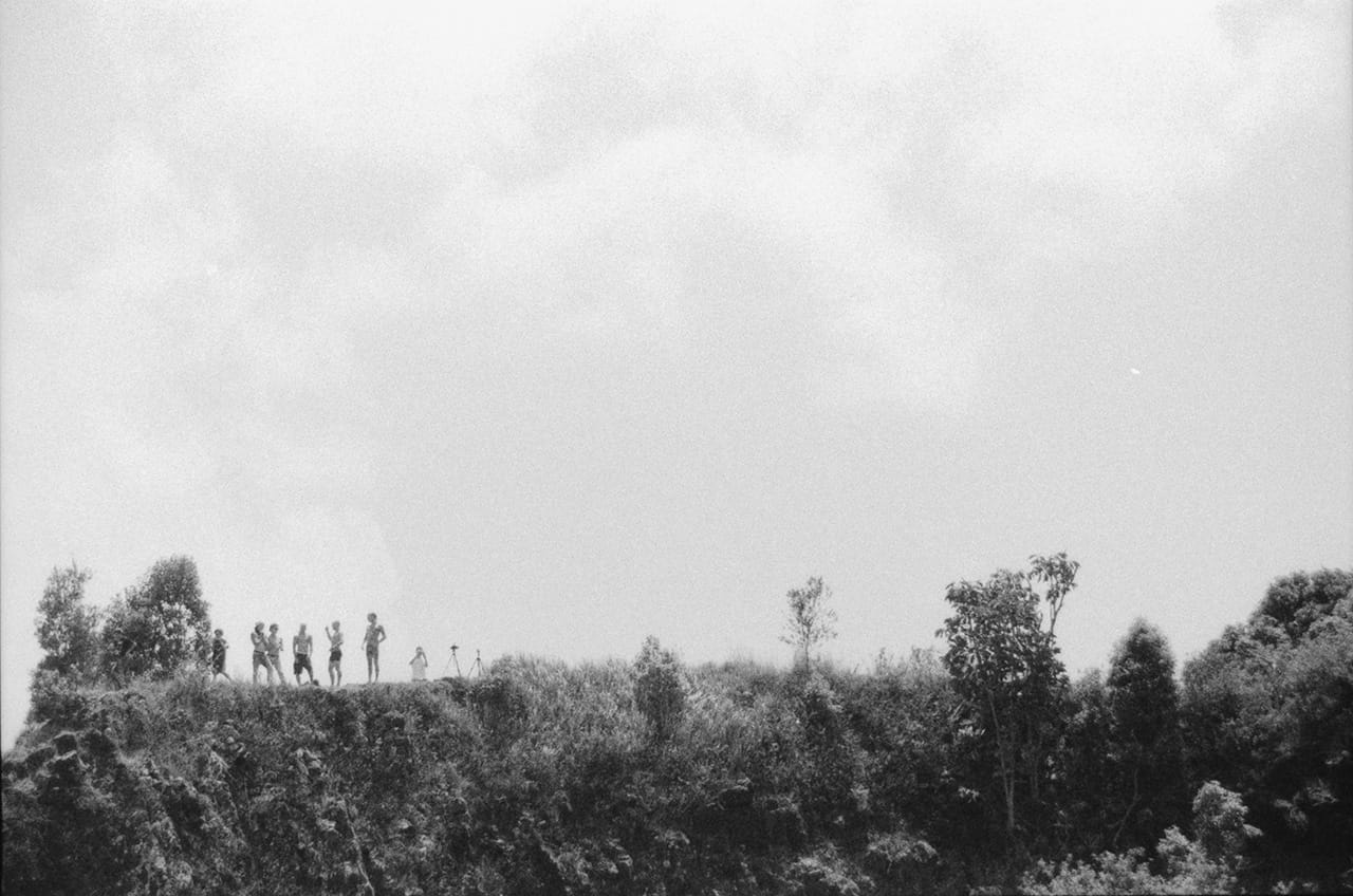 A crowd stands atop the cliff overlooking the Island Quarry - Boredoms - Boadrum111 - Byron Bay November 2011