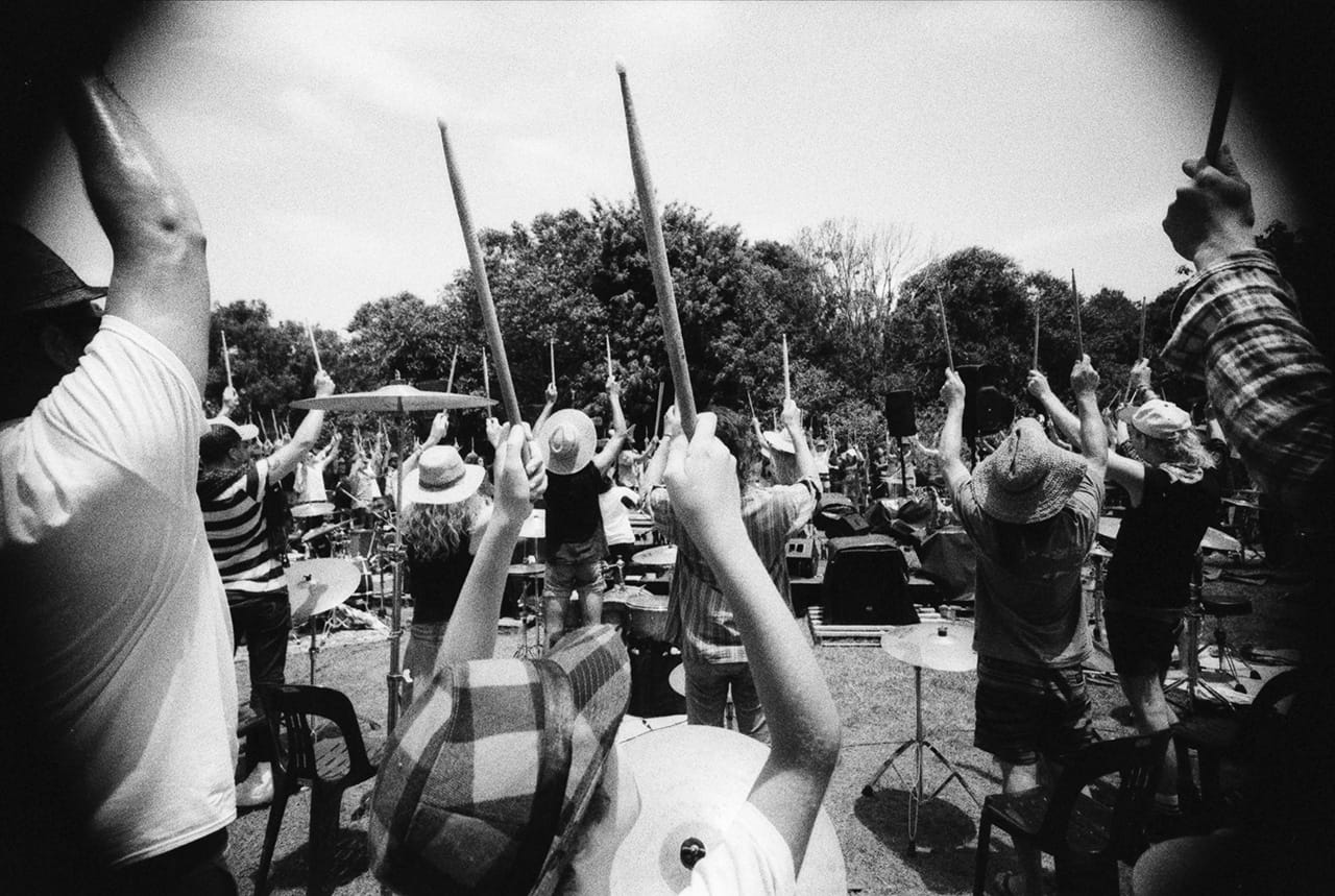 The players await the official Aerial Photography from an approaching helicopter - Boredoms - Boadrum111 - Byron Bay November 2011