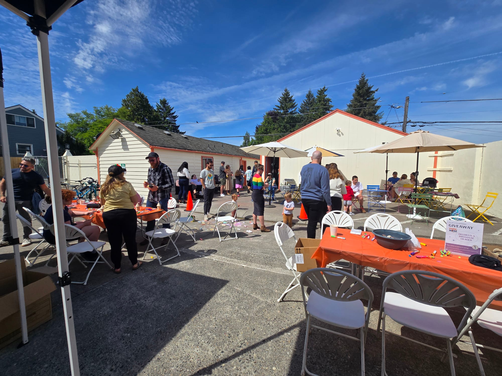 photo of a large back patio with many people talking and standing around.