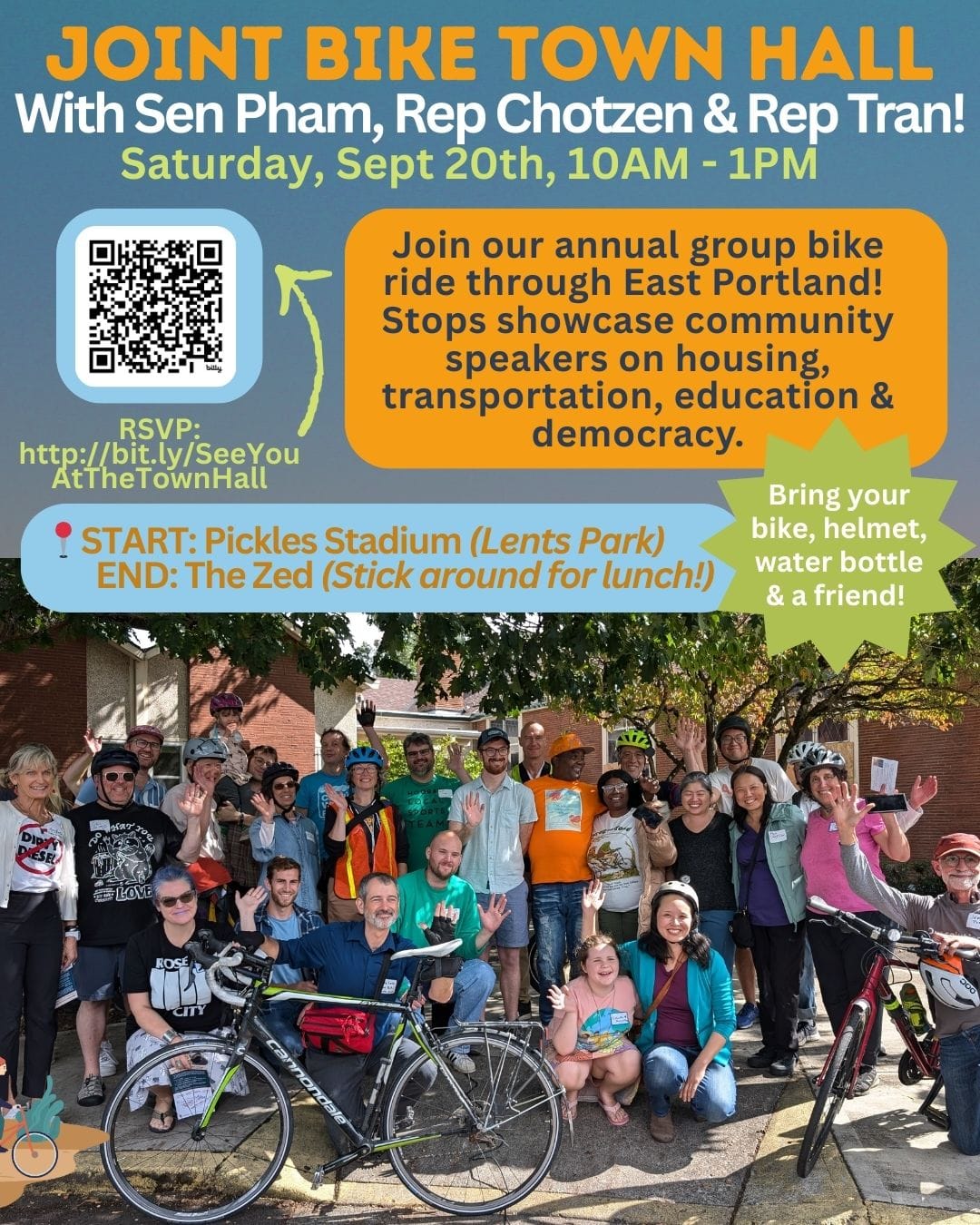 Photo of 25 people smiling. Some are wearing helmets, and there is a bicycle in front of the group.