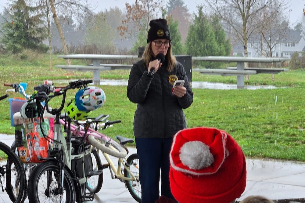 Photo of Michelle DuBarry, Families for Safe Streets Portland board member and event facilitator, reading from her phone.