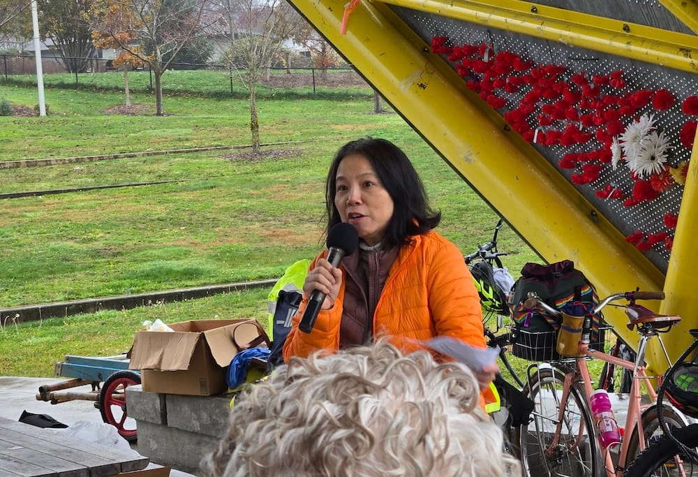 Photo of Rep. Thuy Tran speaking into a microphone